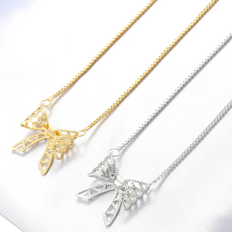 Trendy necklaces for women -Wholesale Sweet Bow Knot Copper Hollow Out 18K Gold Plated Zircon Pendant Necklace