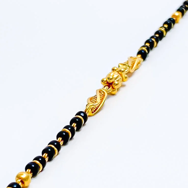 Rose gold bangles for women -Elongated Barrel 22k Gold Black Bead Baby Bracelet